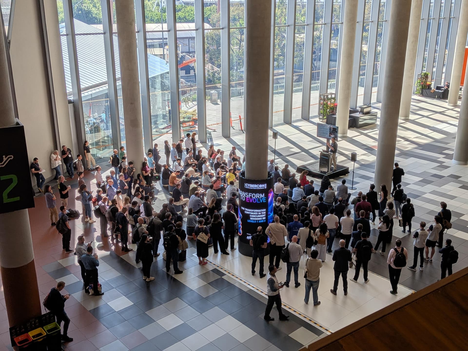 A large standing crowd gathered around the stage as Rawson Wade presents at CyberCon Melbourne 2025